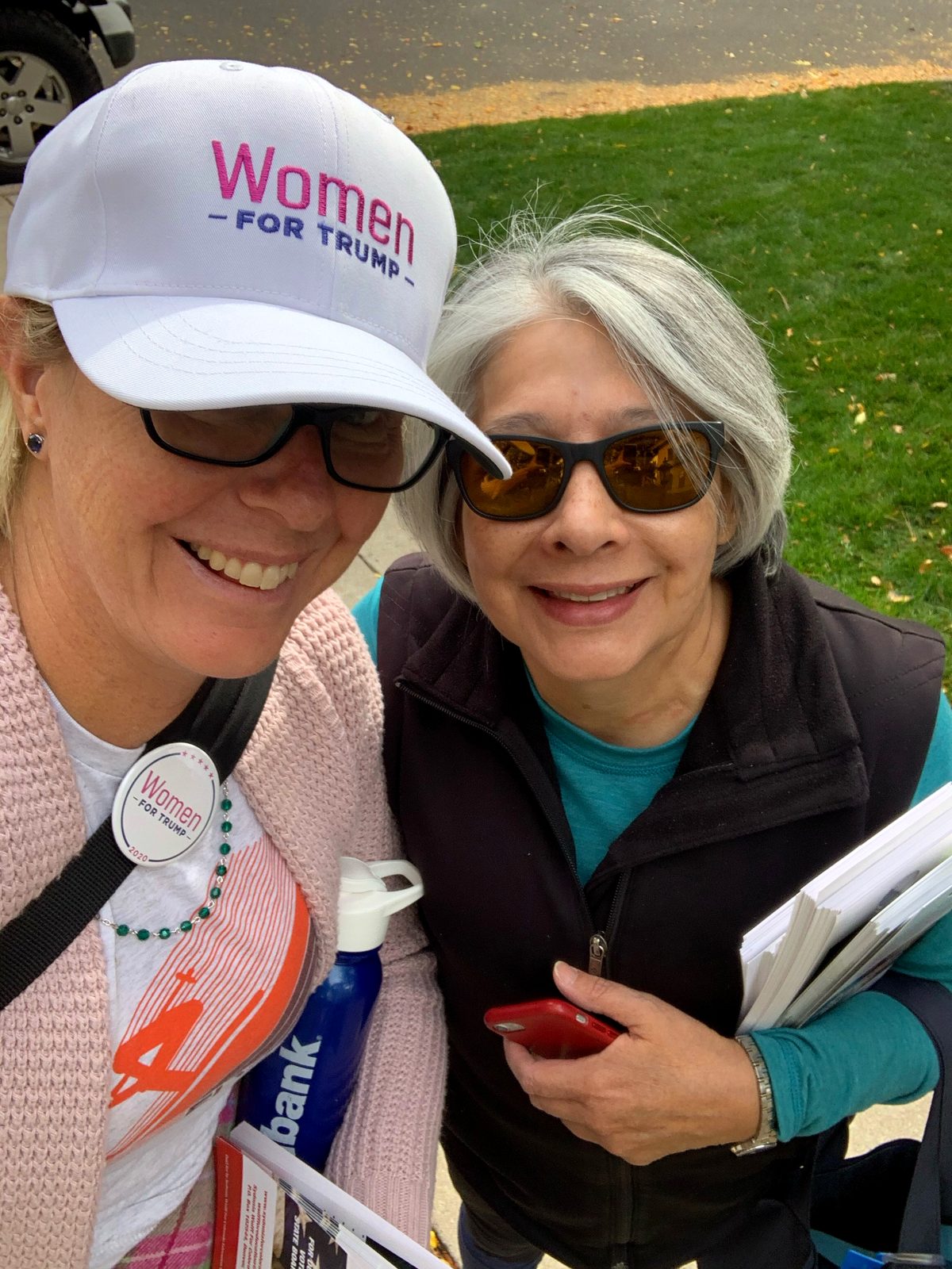 Sydnnia Wulff canvassing with a fellow volunteer, carrying campaign literature